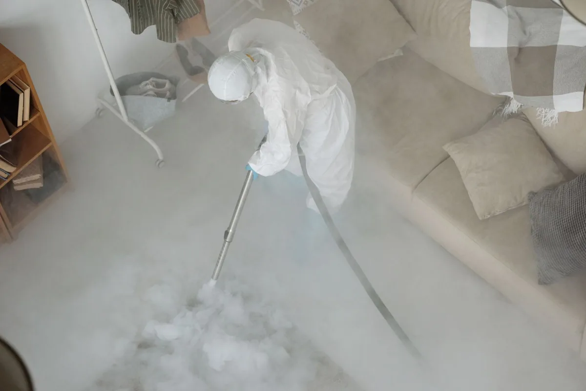 Biohazard cleanup technician in protective equipment, Abernathy, TX
